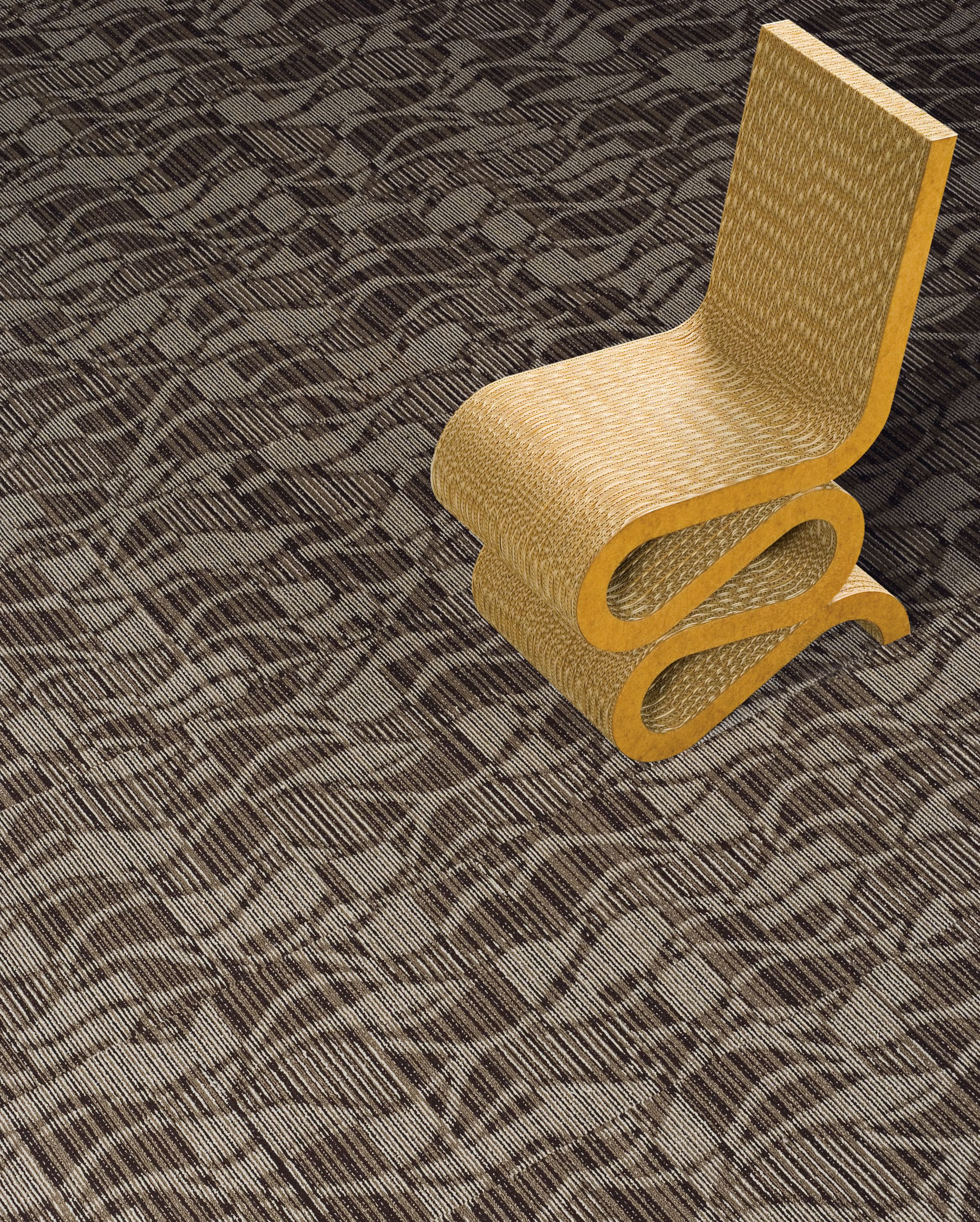 Interface Miramar carpet tile in close up with curvy chair imagen número 1